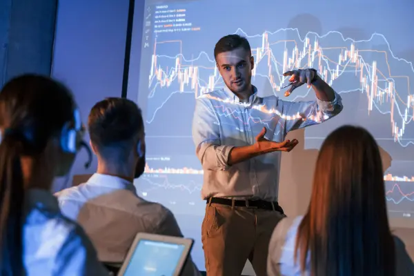 Teacher explaining data graphs to an engaged classroom